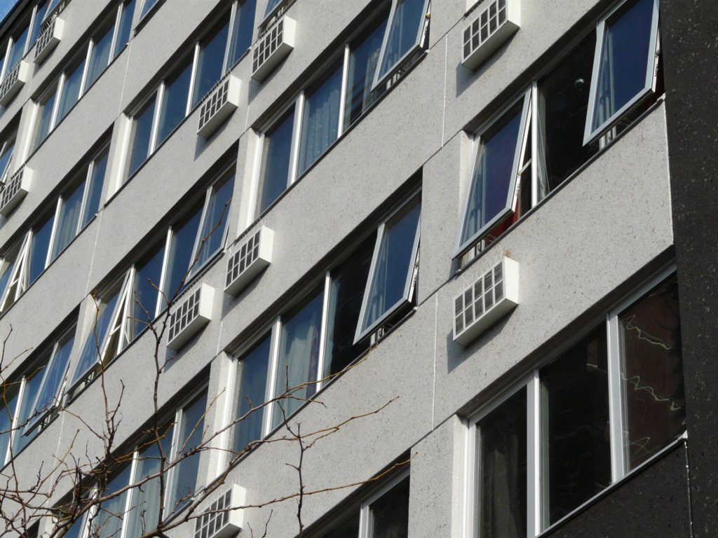 grey high rise building with open windows