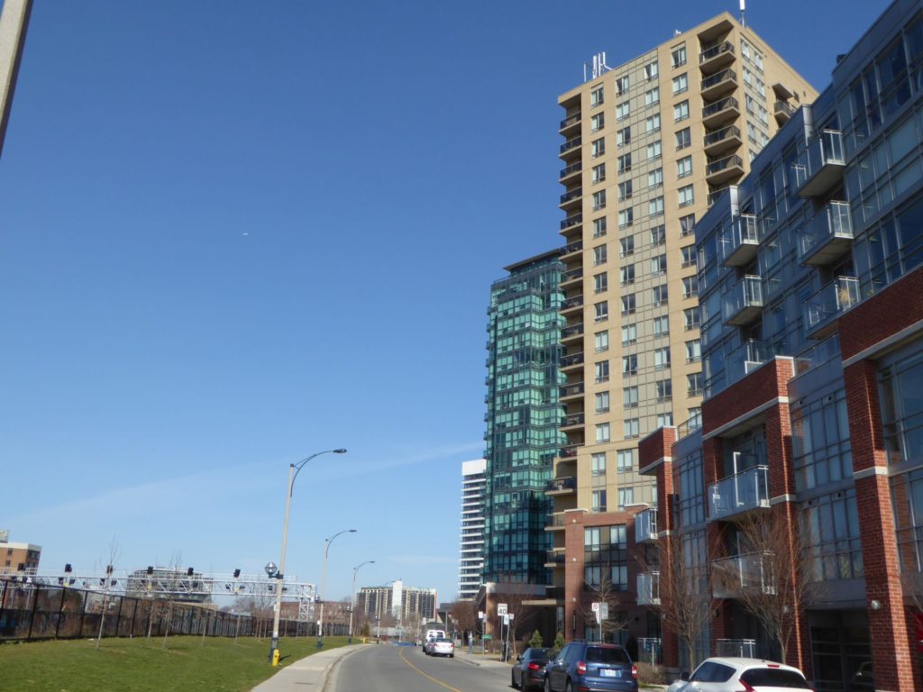 traintracks and greenspace next to highrise building complexes