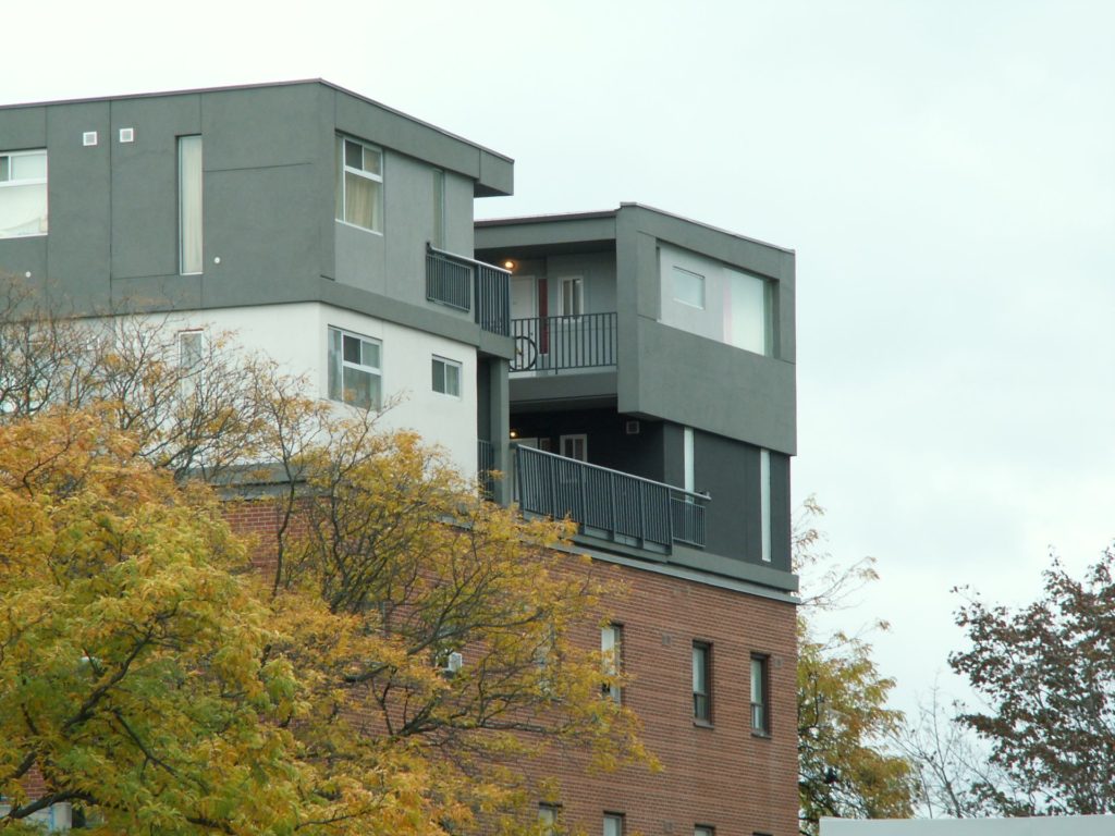 leonard building with large trees in front